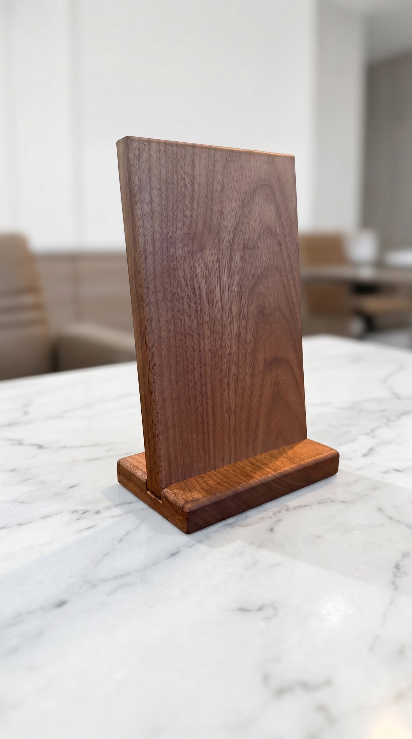 Solid walnut hardwood countertop sign in three-quarter view on marble counter in upscale restaurant setting
