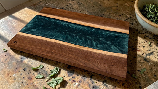 Mesos center-river charcuterie board in live-edge walnut with hunter green epoxy river, top view