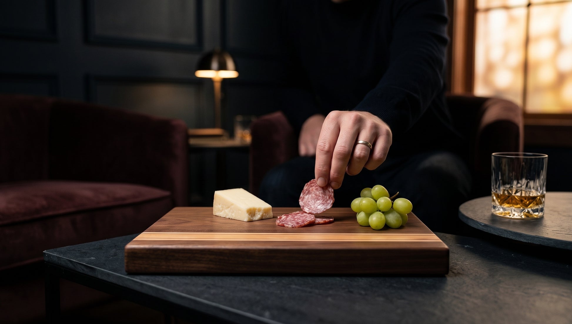Charis Studios edge-grain cutting board with walnut, cherry, and maple stripes, used as a charcuterie board.